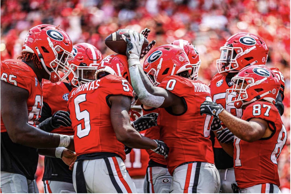 Georgia's offense celebrates teammate Roderick Robinson's ll touchdown